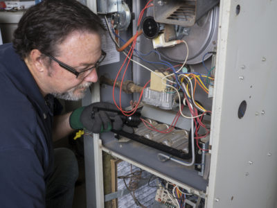 man repairing heater